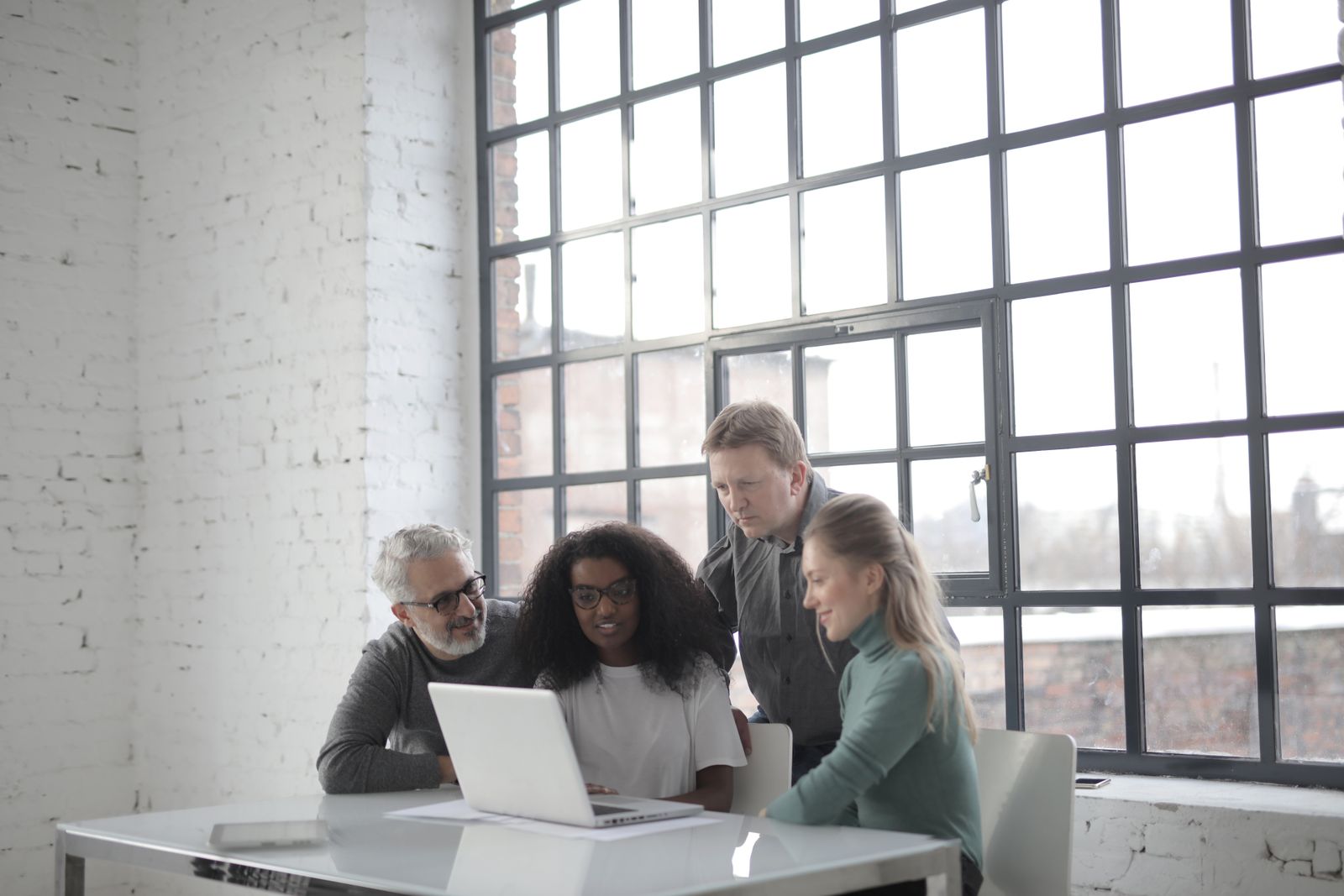 A team building something together at a laptop